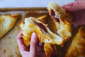 image of hands breaking open a fresh pastelito de guayaba
