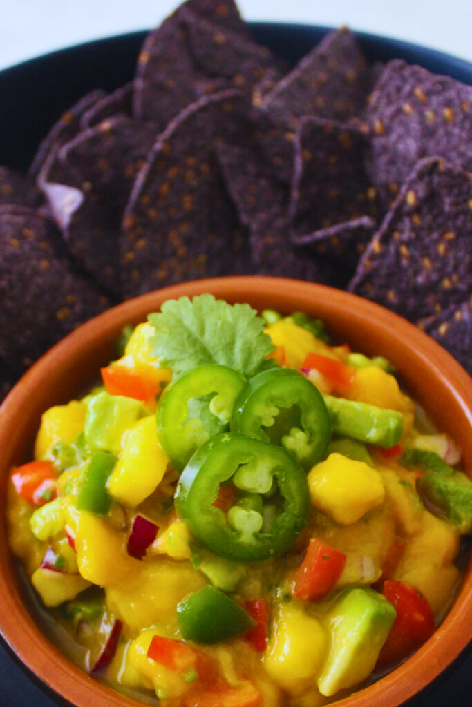 image of mango avocado salsa with purple corn chips