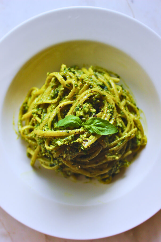 overhead image of peruvian tallerines verde garnished with fresh basil