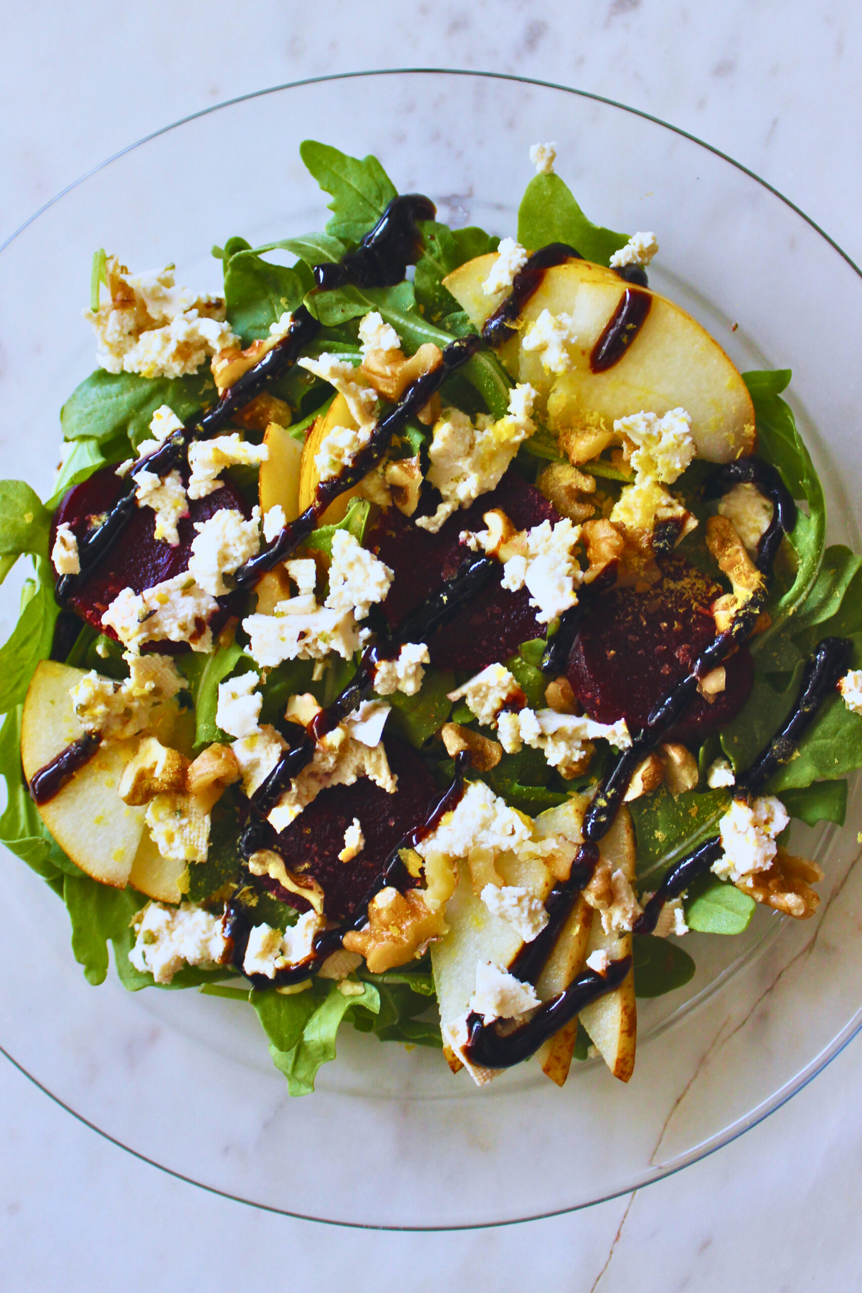 image of arugula, tofu feta, pear, beet salad