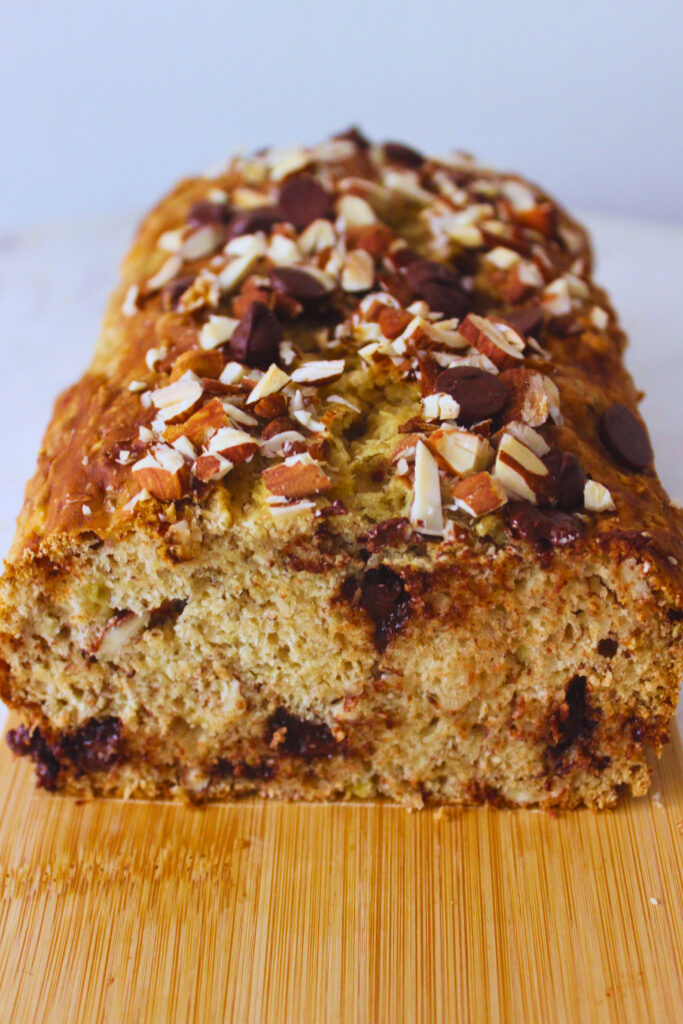 image of banana bread that's been sliced on a wooden board
