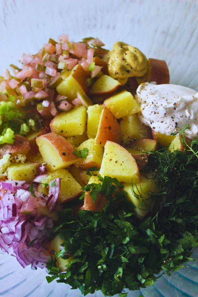 image of potato salad ingredients chopped and prepped in a large bowl