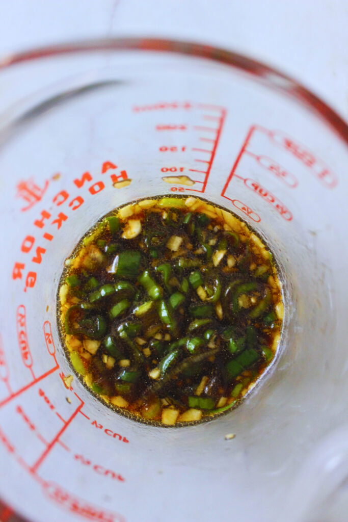 overhead image of a glass container with sauce mix for silken tofu recipe