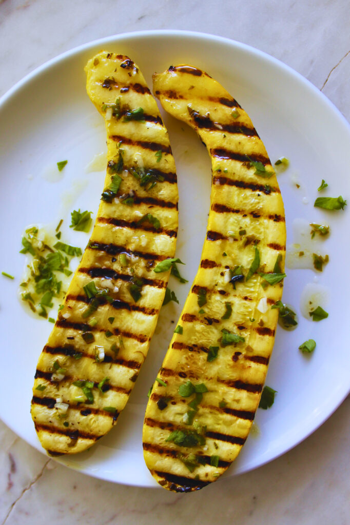Grilled yellow summer squash topped with fresh parsley