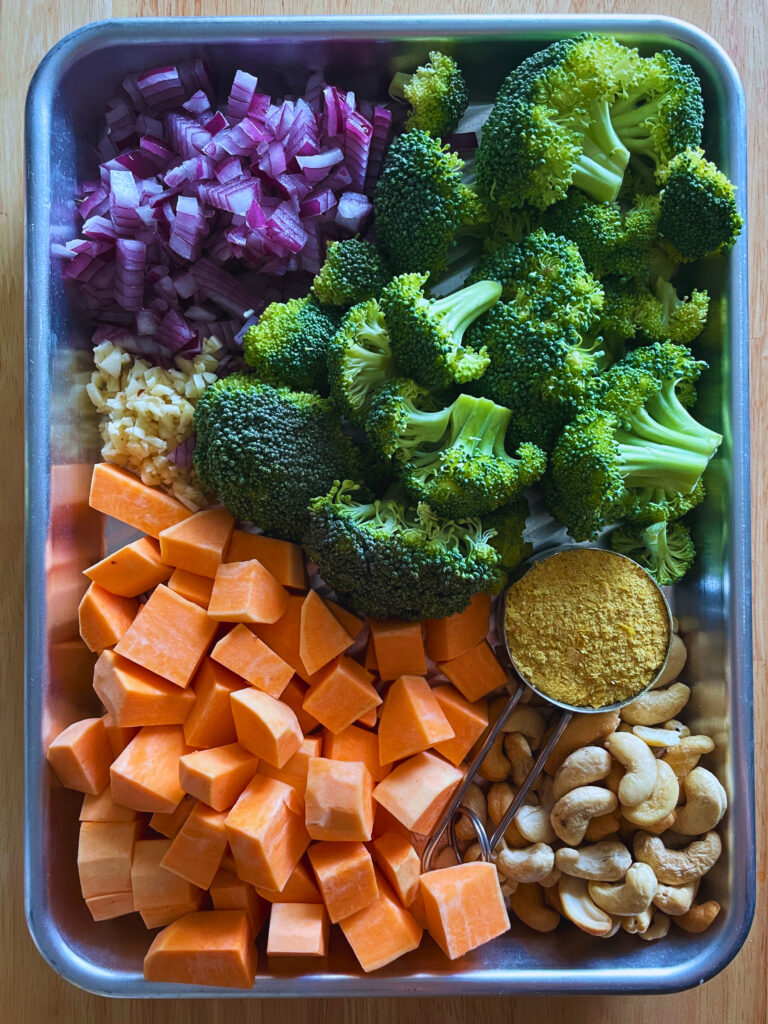 sheet pan tray with prepped ingredients for making creamy sweet potato broccoli soup