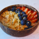 image of overnight oats topped with strawberries, blueberries and hemp seeds