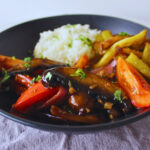 Mushrooms cooked with onions garlic and tomatoes served with white rice and French fries