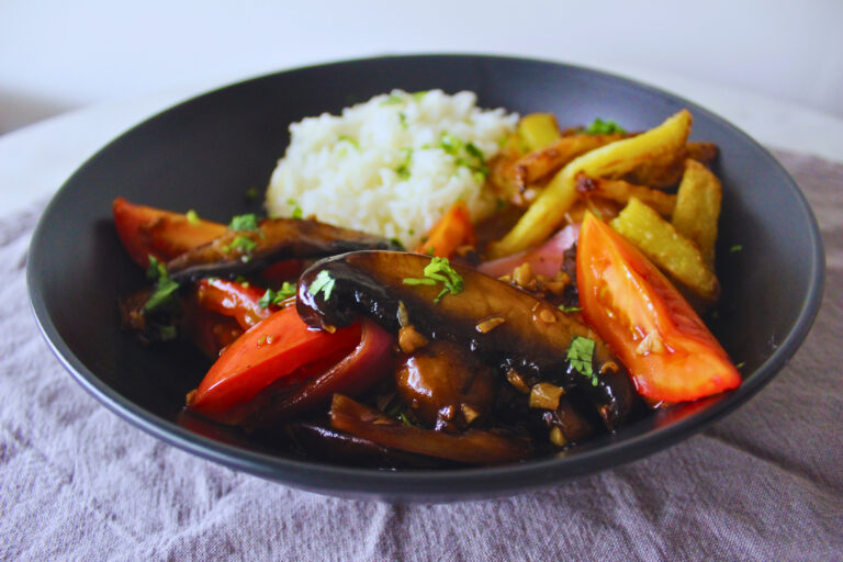 Mushrooms cooked with onions garlic and tomatoes served with white rice and French fries