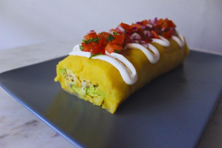 Image: Causa (pionono style)topped with mayo and pico de gallo