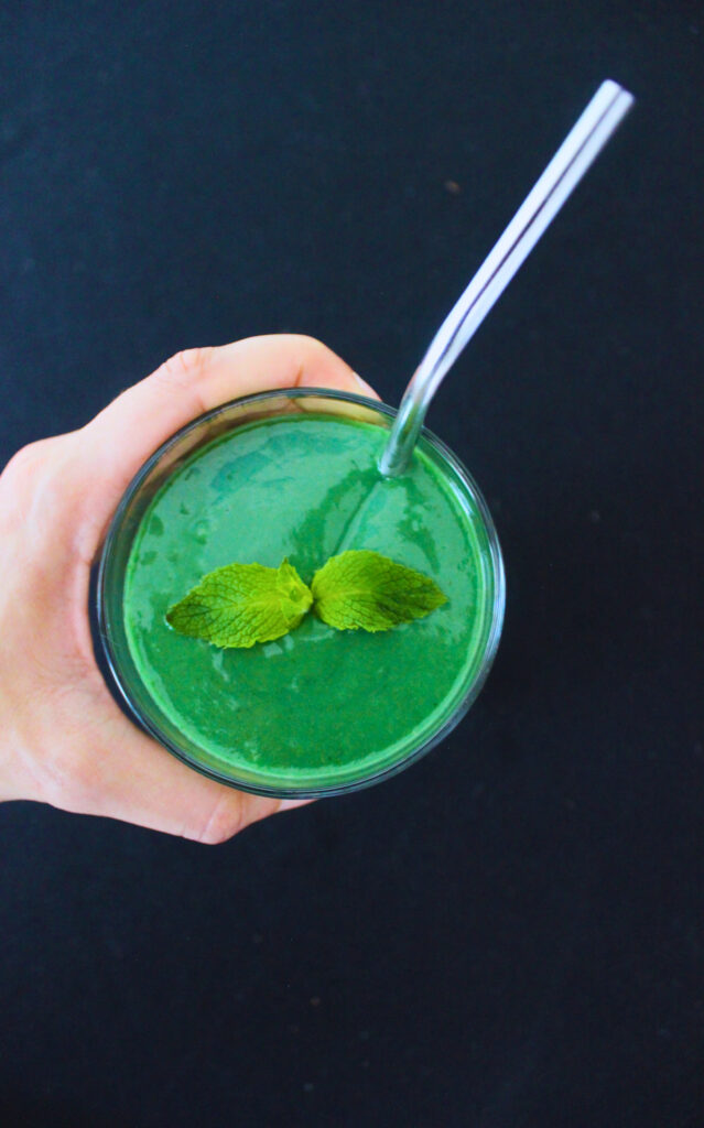 Image: Vibrant green smoothie in hand.