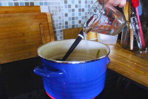 Image: Heating up frozen sauce with water on stove top.