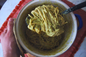 Overhead Image: Pasta in a pot with green sauce