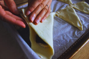 Image of pastry dough folded to make a triangle