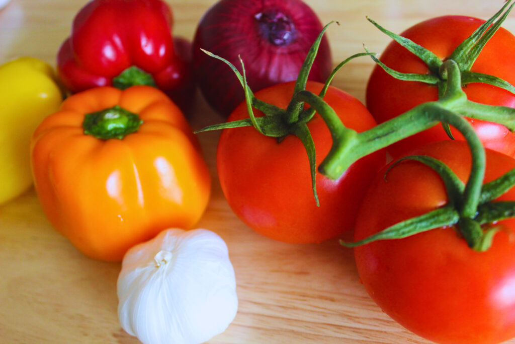image of tomatoes, bell peppers, onion and garlic