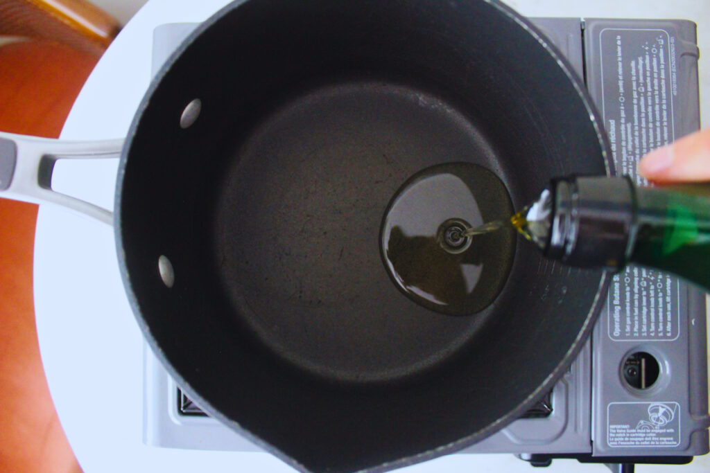 Image of oil being poured into pot for canchitas