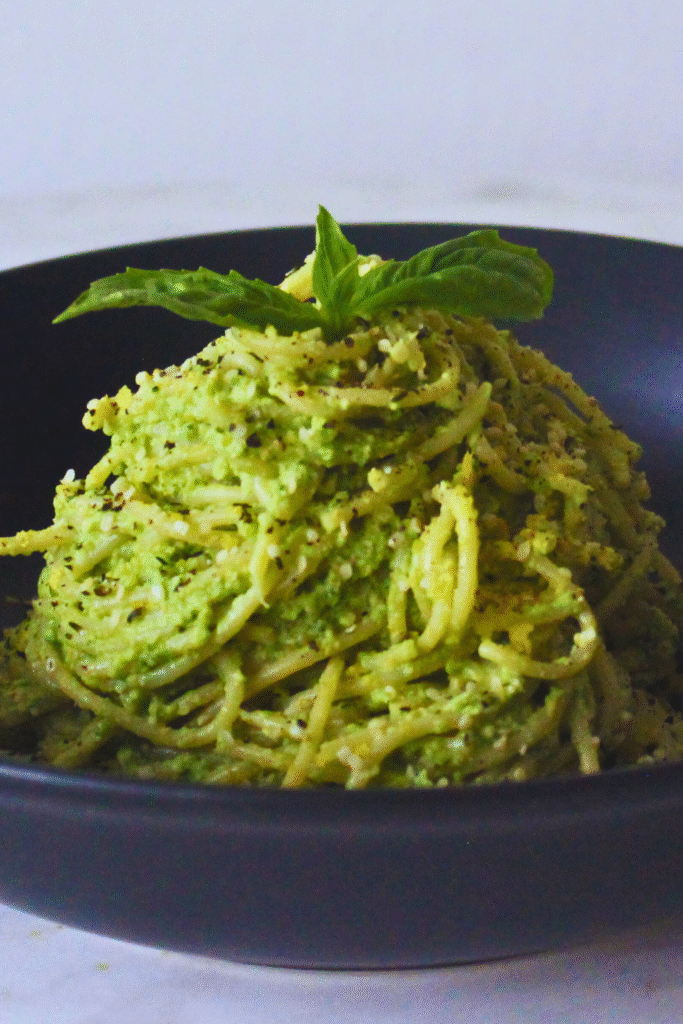Image of Green Goddess Pasta served on a plate garnished with fresh basil and black pepper