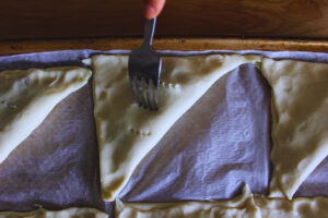 Image of pastry top being poked with a fork