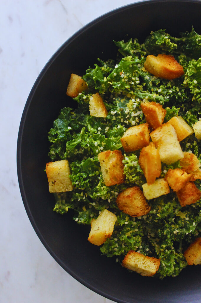 image of avocado massaged kale salad with homemade croutons