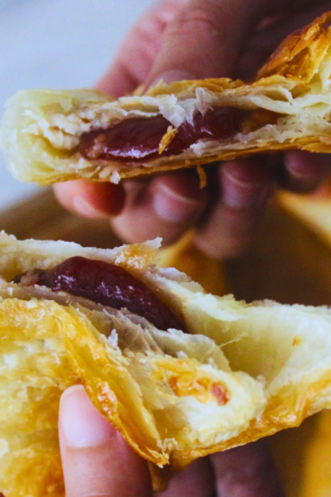 image of hands pulling apart a guava pastelito