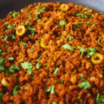 Image of frying pan with picadillo in it, some olives visible