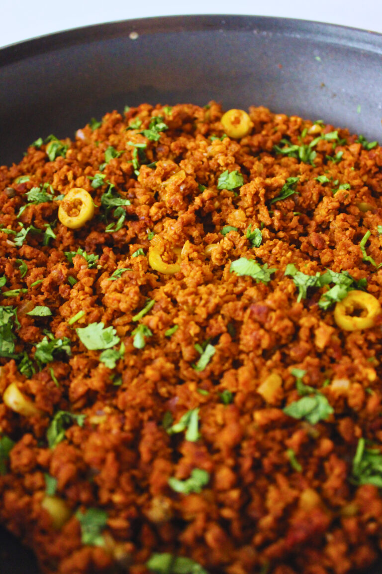 Image of frying pan with picadillo in it, some olives visible