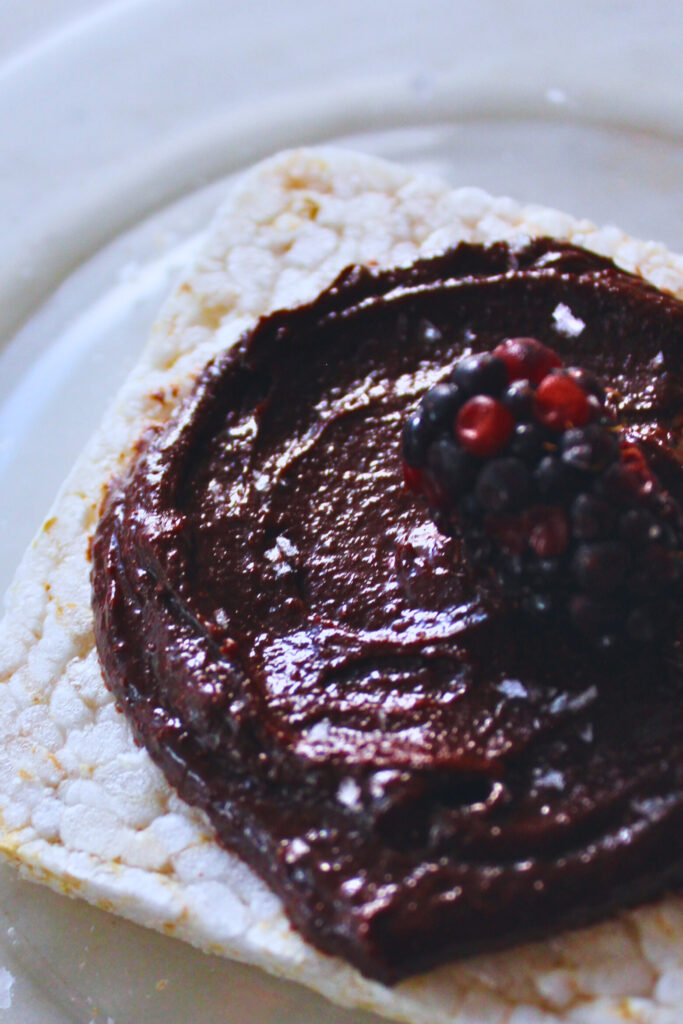 image of rice cake with chocolate tahini spread over the top