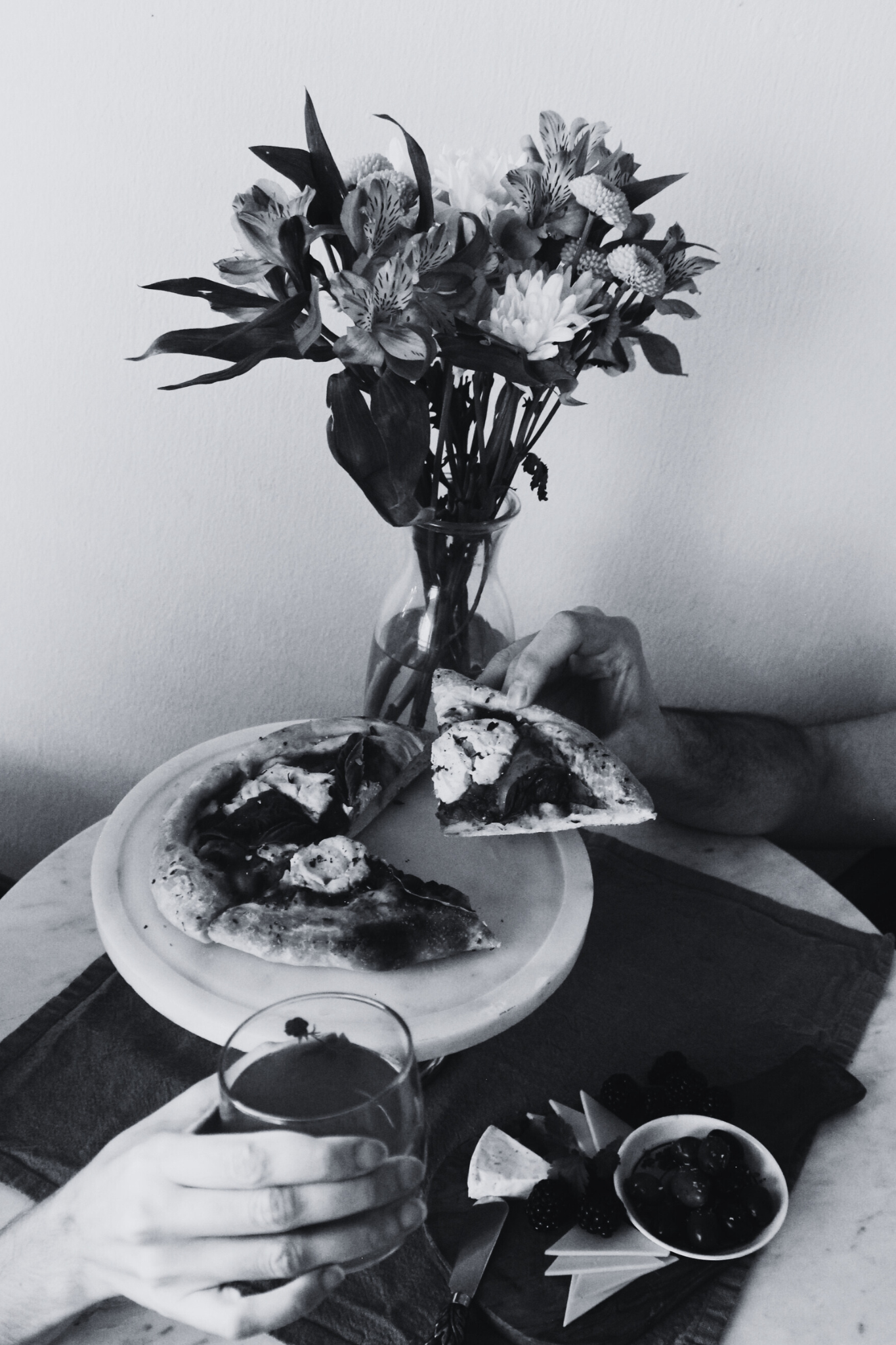 image of table set with a couple enjoying drinks and pizza