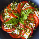 overhead image of tofu tomato basil caprese salad in blue plate.