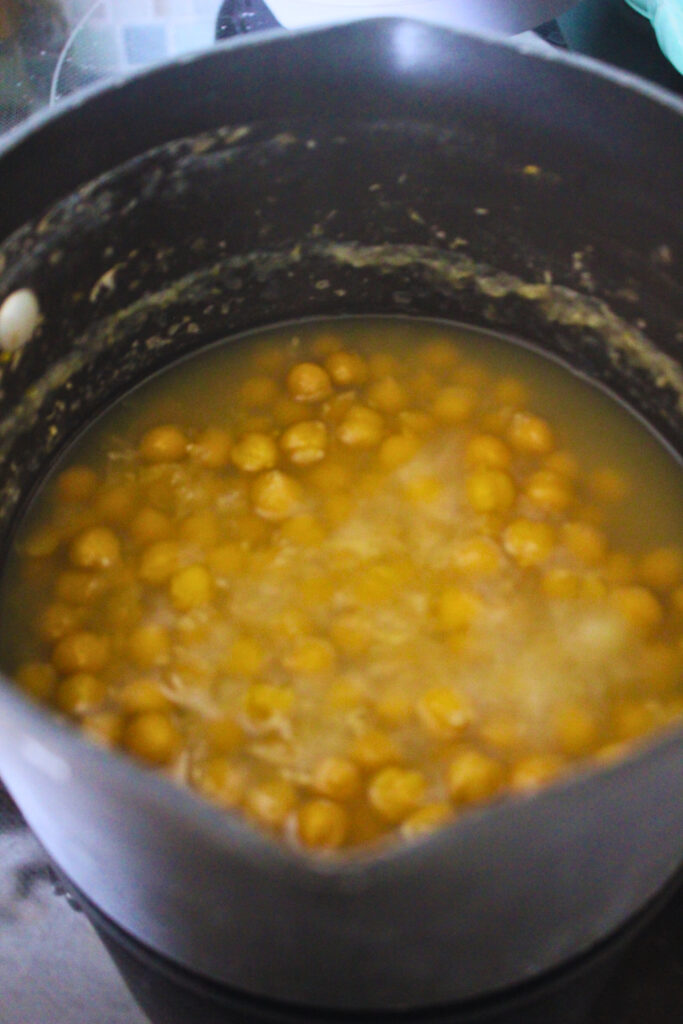 Overhead image of boiling chickpeas with baking soda for a creamier hummus