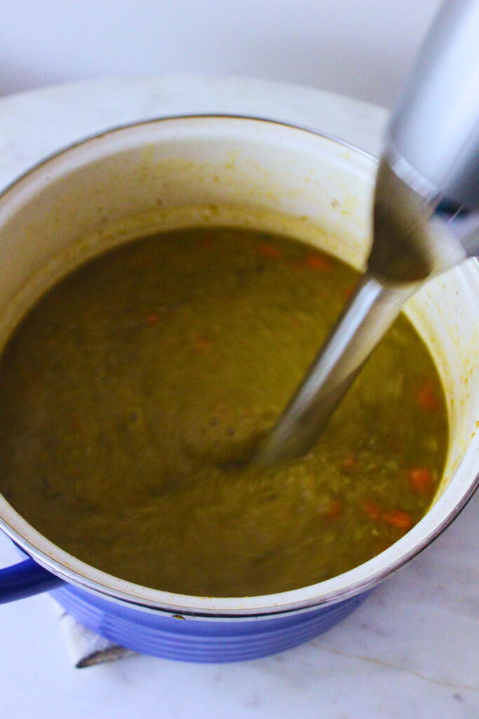 blending the split pea soup with an immersion blender