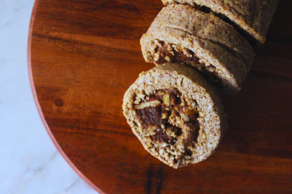 overhead image of raw cinnamon rolls on wooden cutting board