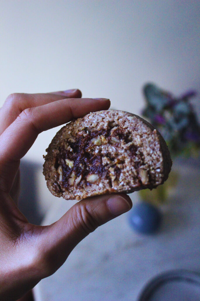 image of a hand holding a slice of raw cinnamon roll