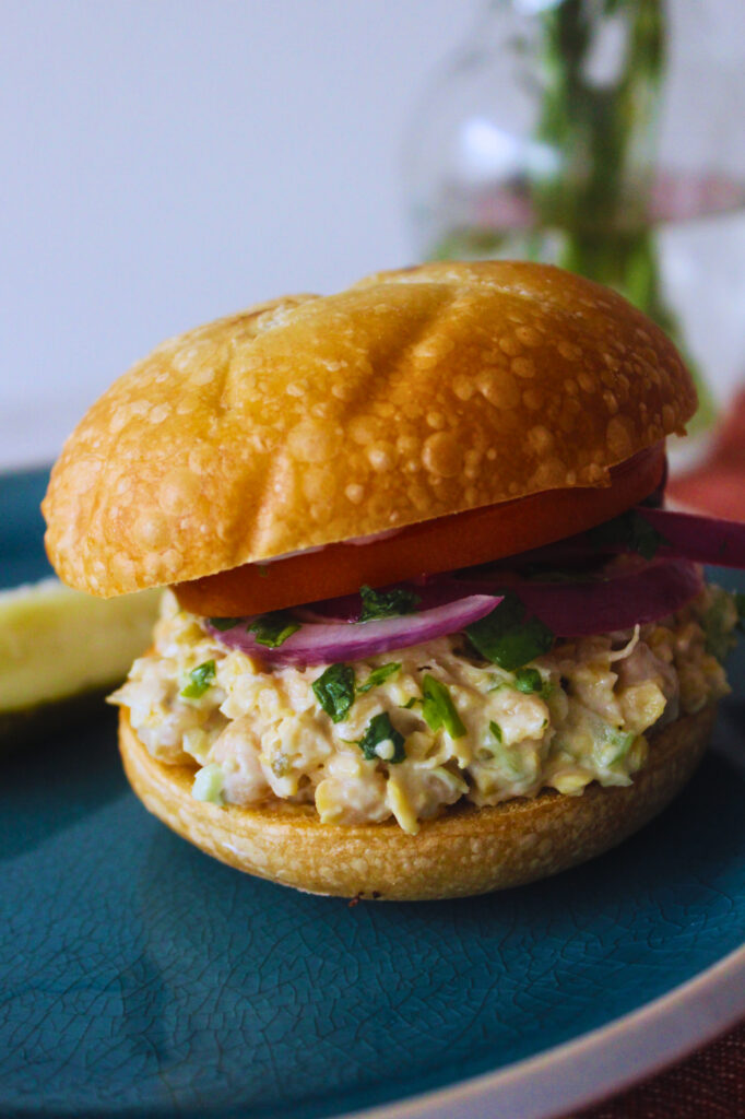 mashed chickpea sandwich with tomato and onion