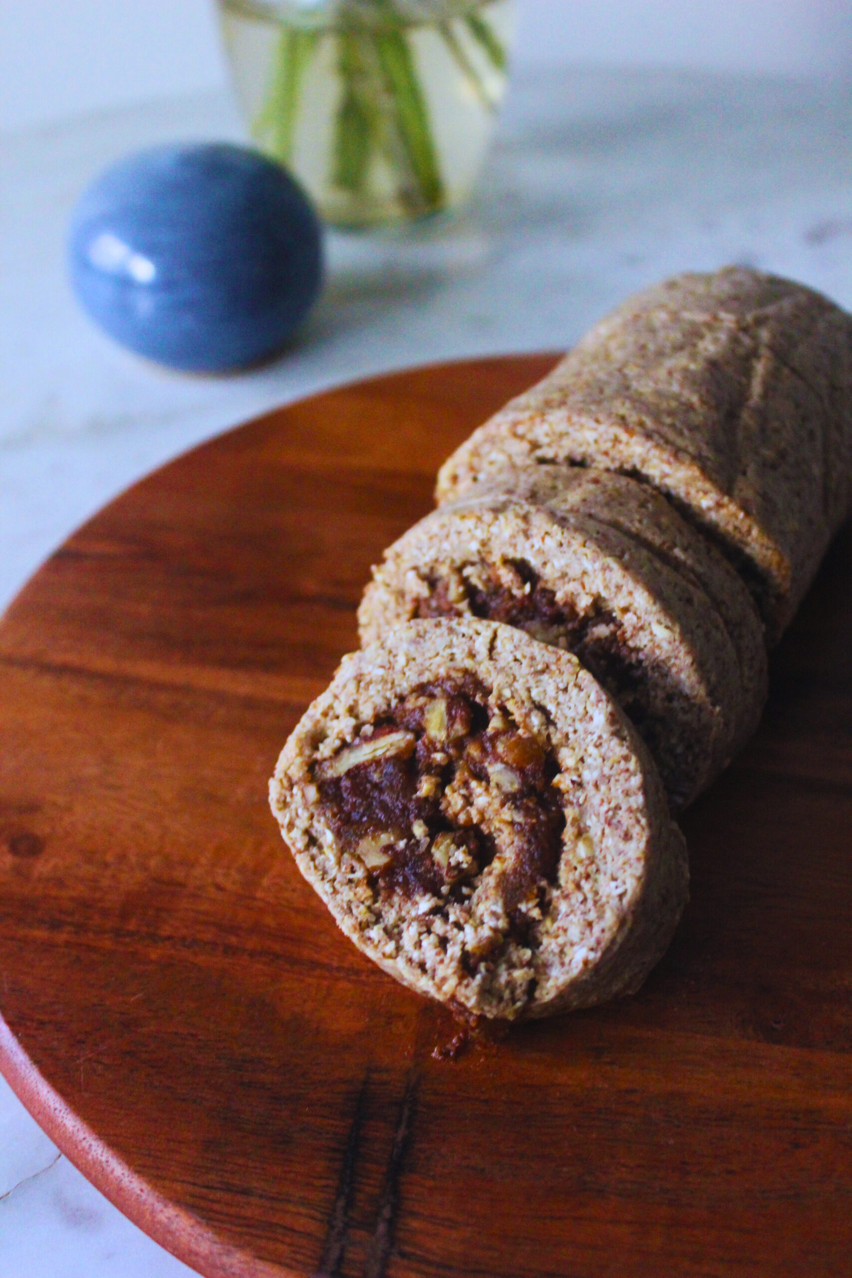 image of raw cinnamon roll log on a wooden board