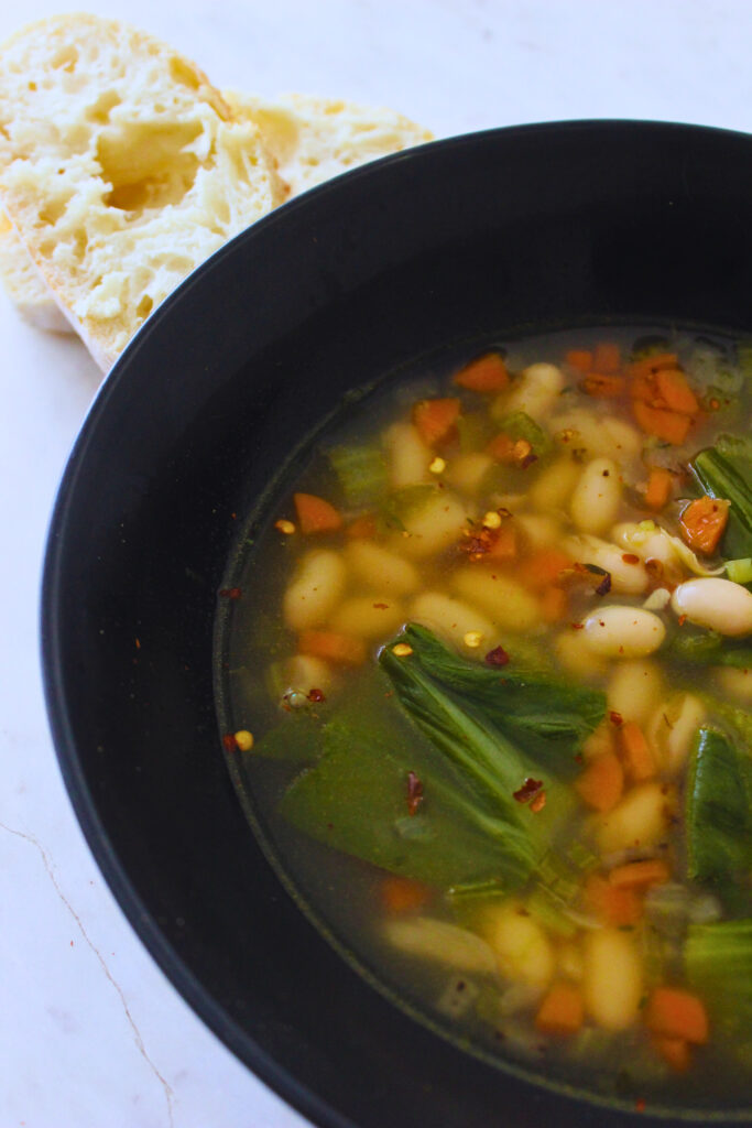 image of vegan veggie soup with a side of bread