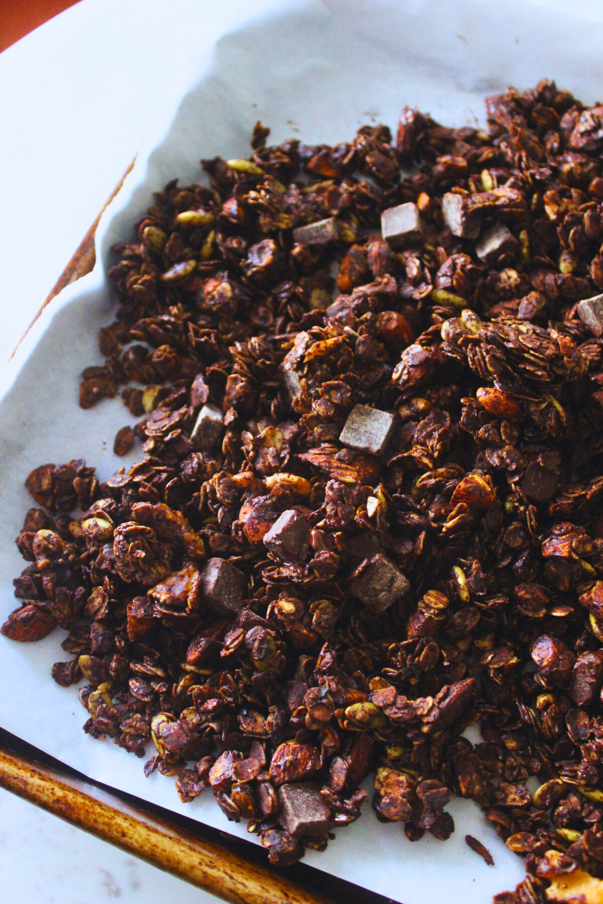 image of freshly made granola with chocolate, nuts and seeds