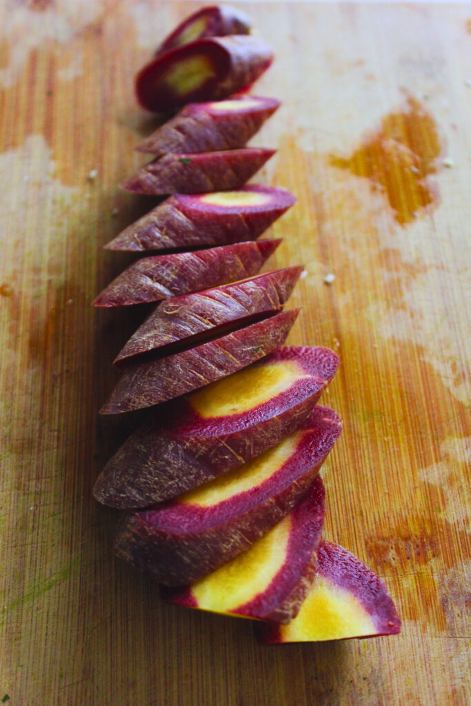 image of purple carrot cut into diagonal discs