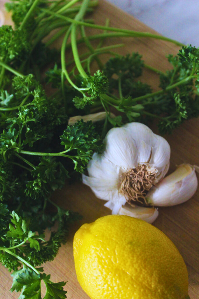 fresh parsley, a garlic bulb, a lemon