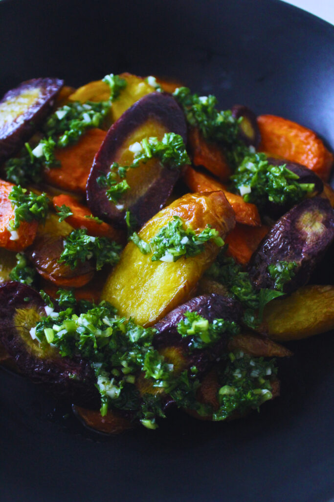 plate of roasted rainbow carrots with parsley sauce 