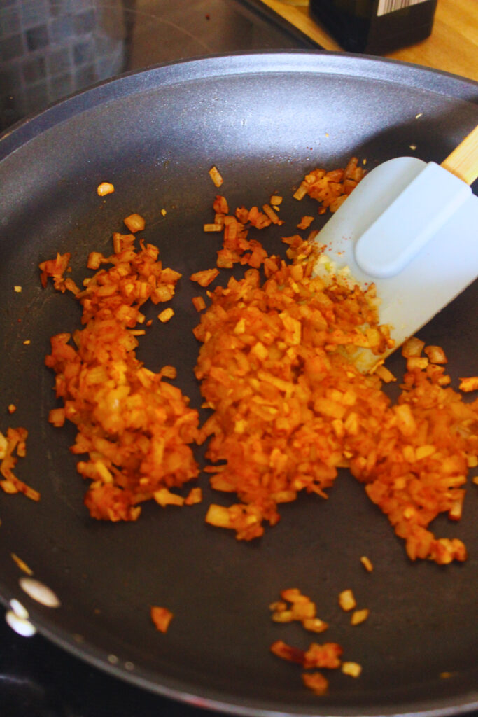 image of sauteing onion, garlic, and paprika