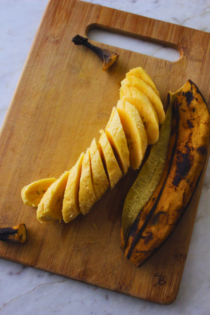 image of a ripe plantain that has been peeled and sliced