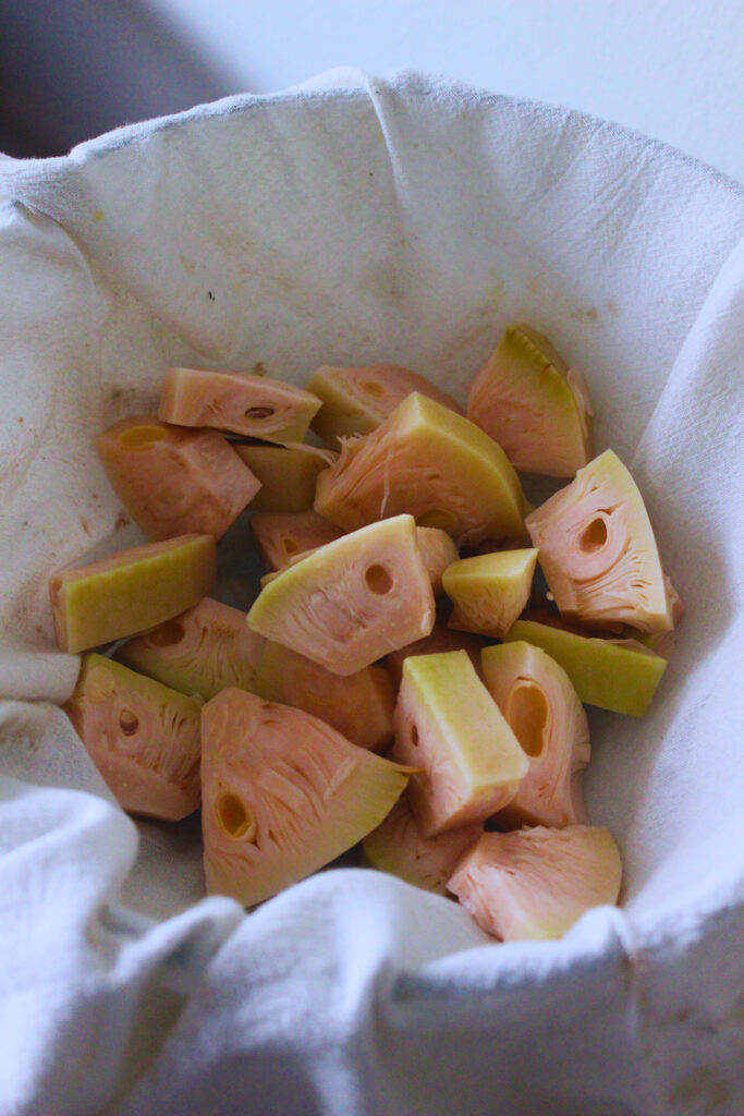 image of canned jackfruit pieces on a clean kitchen towel ready to squeeze out the brine