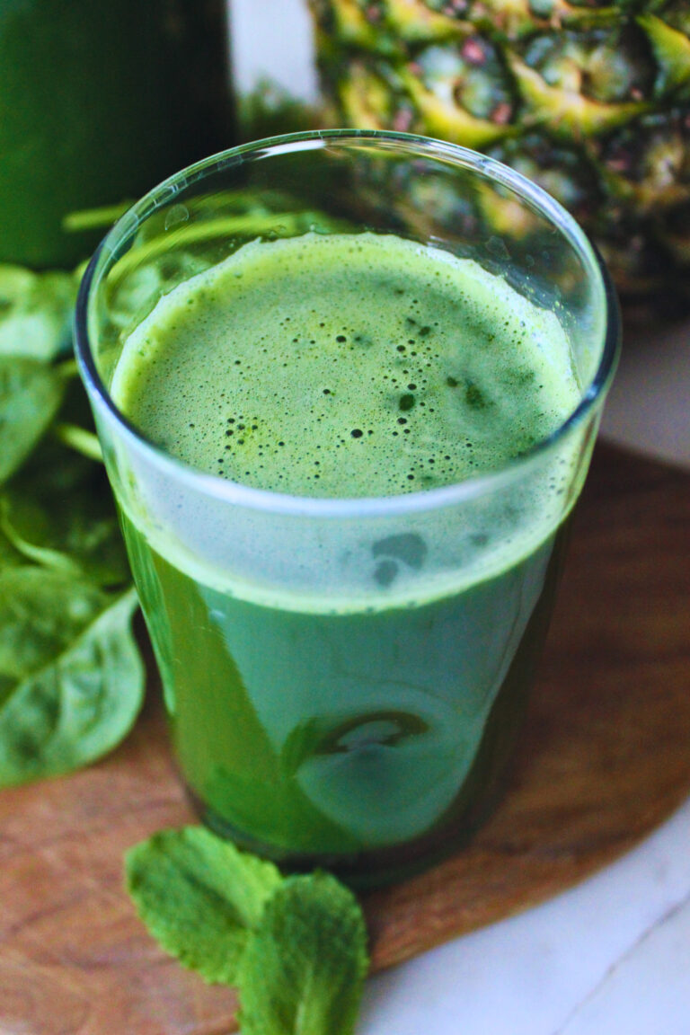 image of cold pressed green juice with spinach and mint leaves