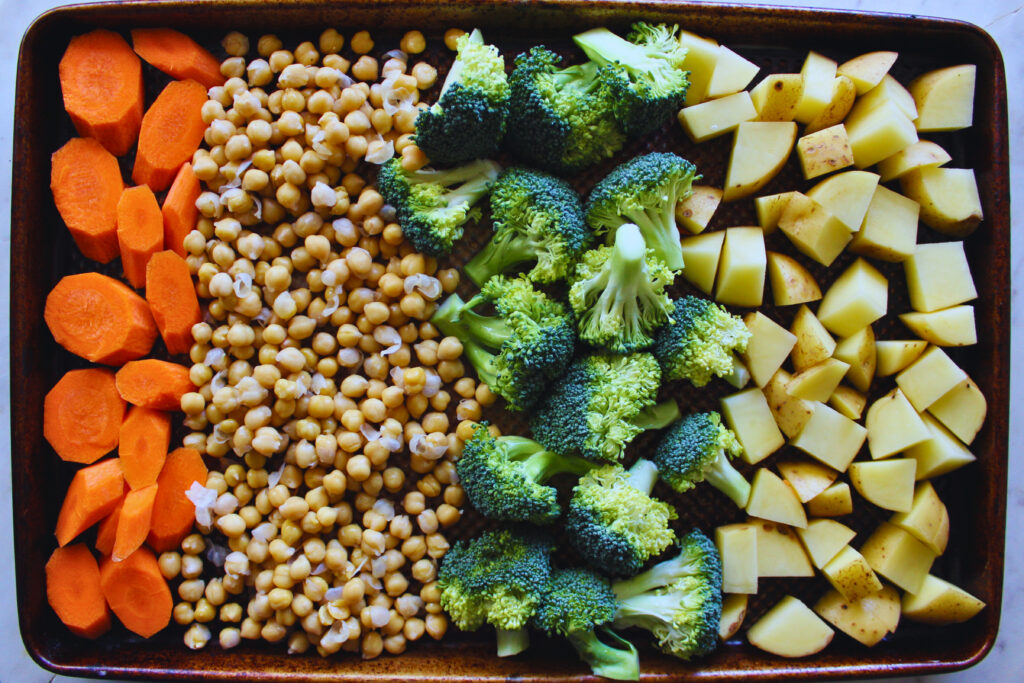 overhead image of veggies and chickpeas ready for baking