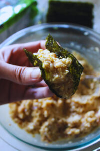 hand holding a creamy chickpea seaweed bite