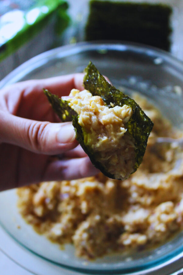 hand holding a creamy chickpea seaweed bite